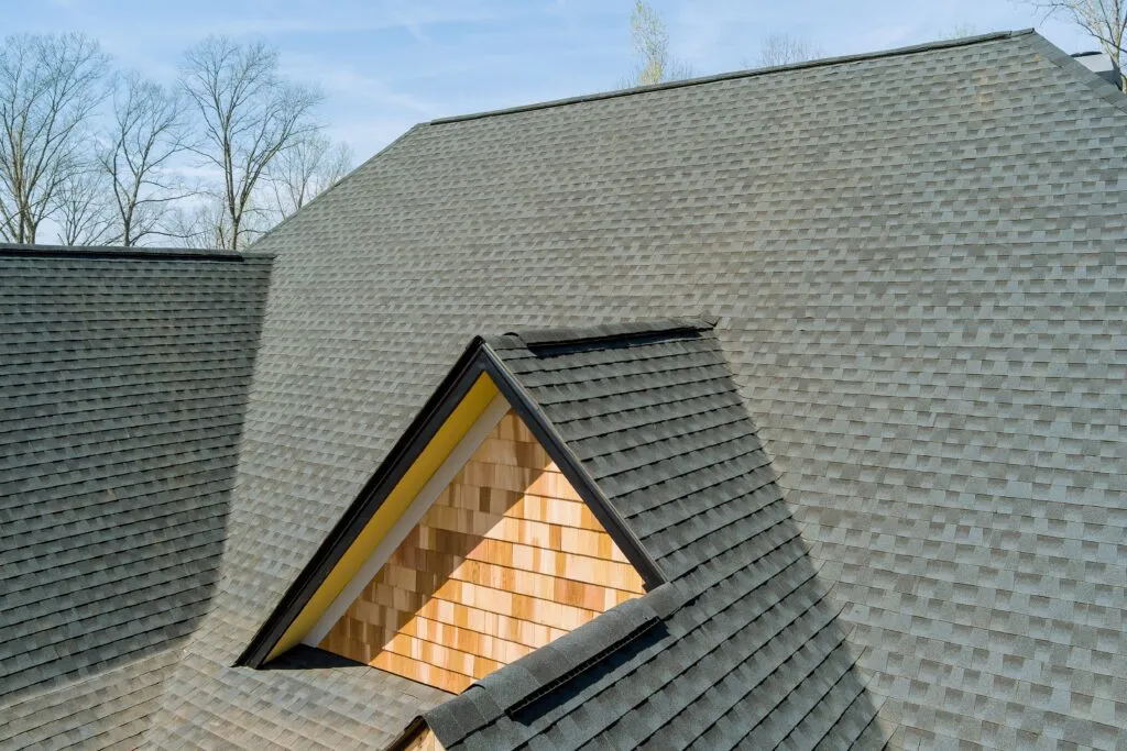 Gray asphalt shingle roof with vent and wooden accent wall roofing contractor near me SC
