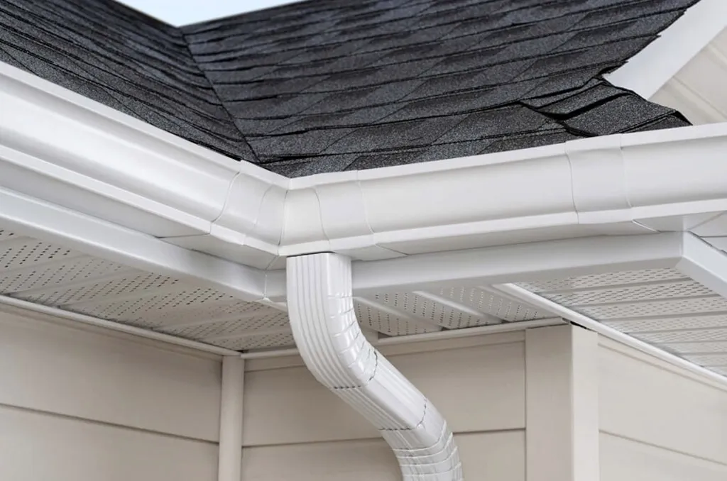 Modern house gutter system and roof shingles close-up
