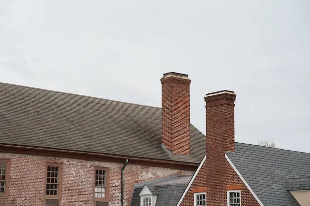 Historic brick chimney stacks on a traditional building roof